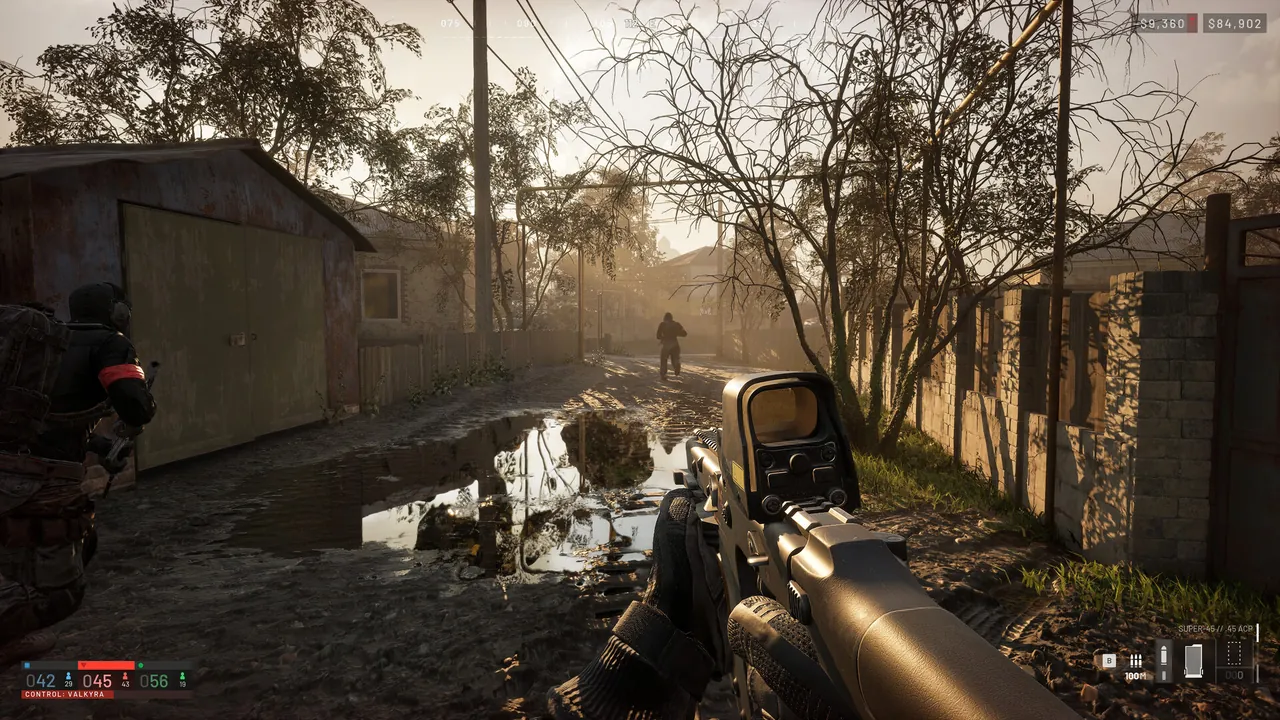A first-person view down a muddy alley between sheds in morning haze, weapon raised at a distant figure.